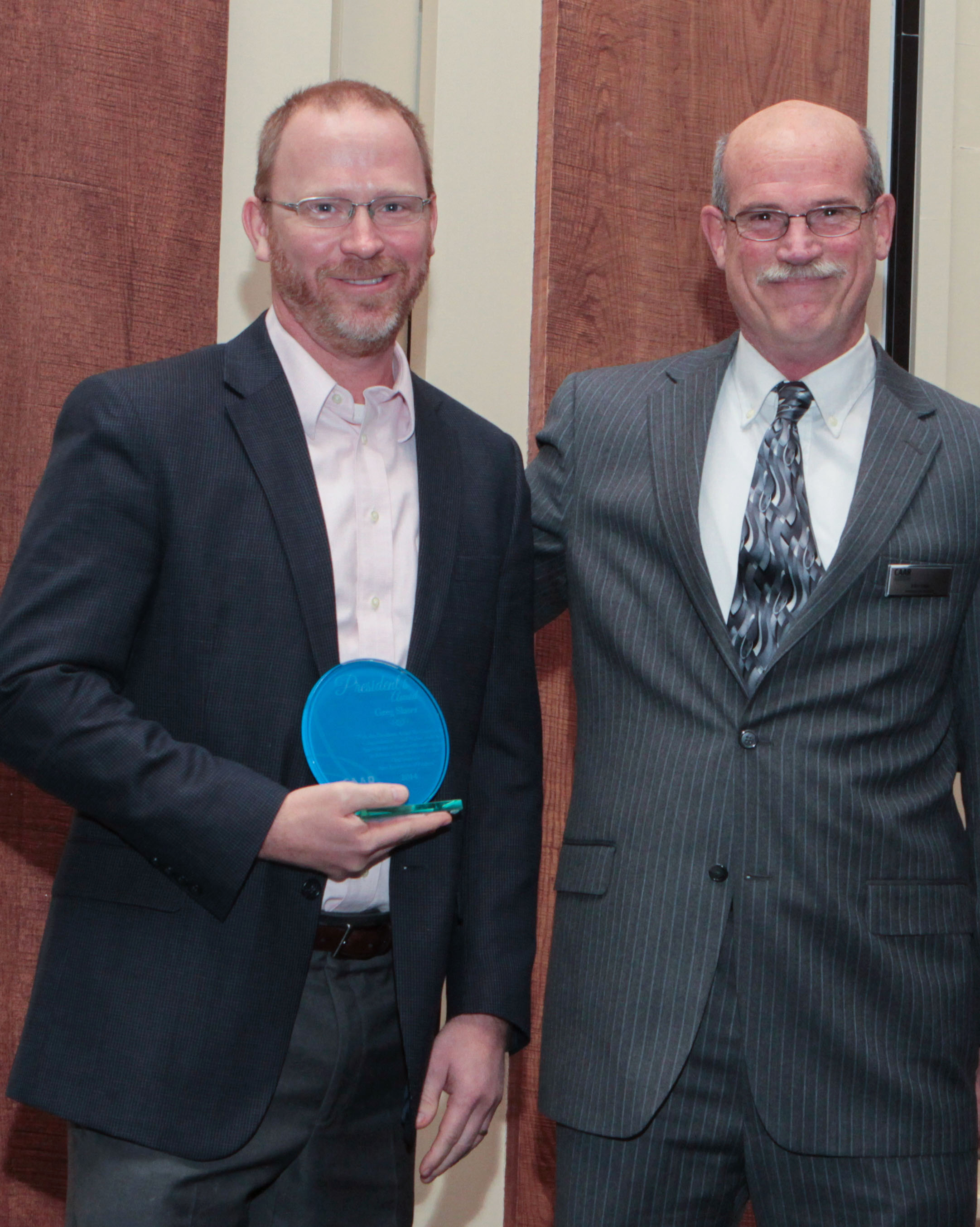 Greg Slater accepts the 2014 President’s Award from President, John Ince