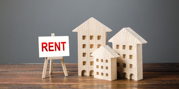 Three figures of houses and an easel with the word rent. Real Estate Agent services, search for optimal options. The concept of temporary rental housing and real estate. The choice between renting and buying.